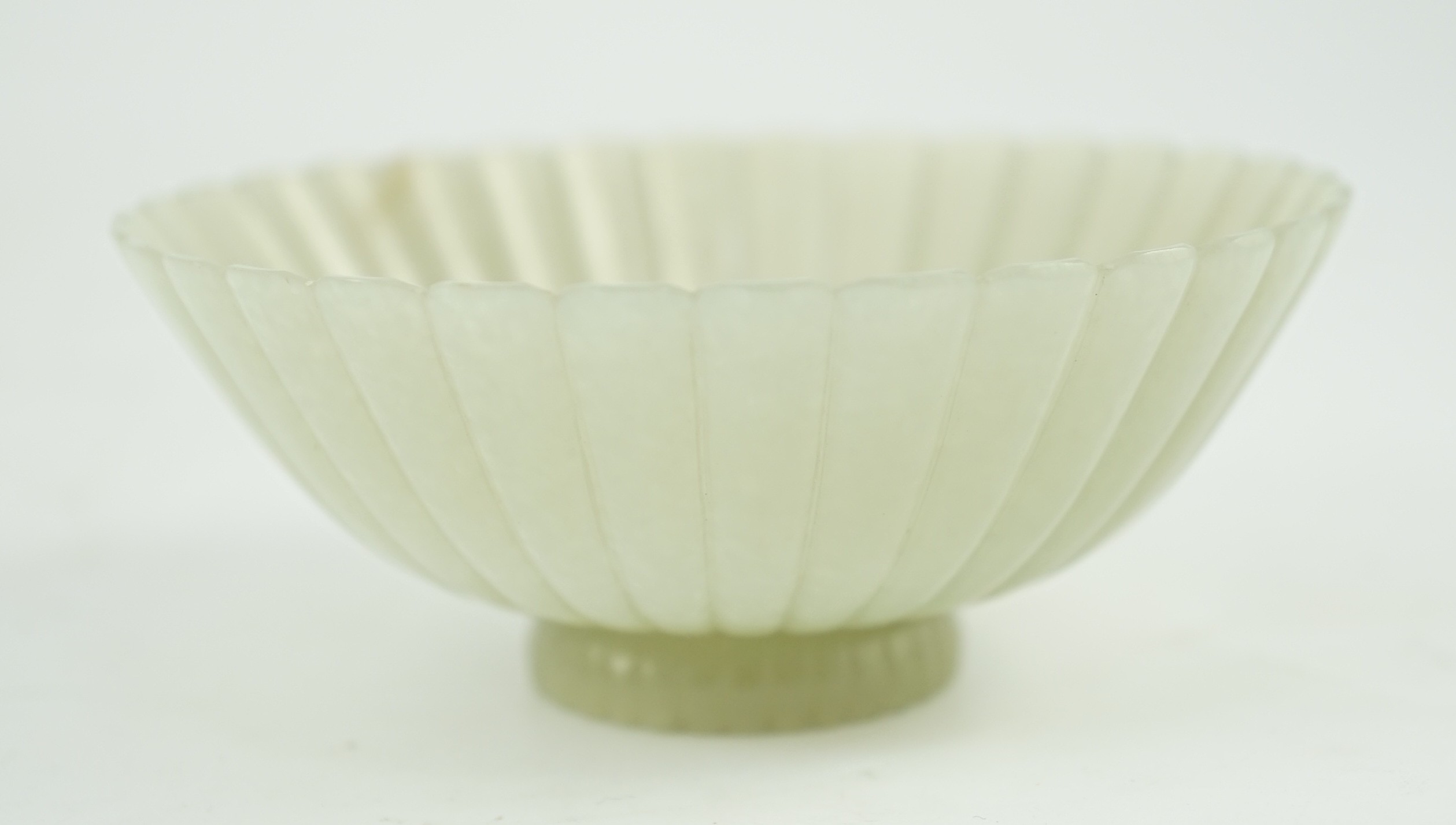A fine Chinese Mughal style celadon jade ‘chrysanthemum’ bowl, 18th/19th century, 9.4cm diameter